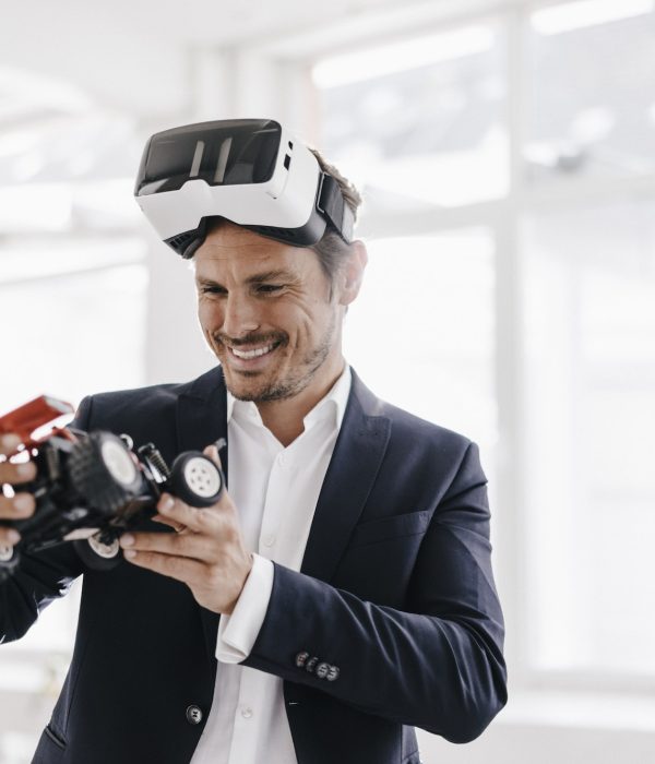 smiling-businessman-wearing-vr-glasses-looking-at-toy-racing-car.jpg smiling-businessman-wearing-vr-glasses-looking-at-toy-racing-car.jpg